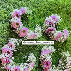 A set of four matching hair brooches or clips for bridesmaids. These are made with baby's breath and pink flowers and can be easily clipped into an updo or braid.
