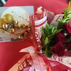 A classic gift combo featuring a white and gold cake and a bouquet of red roses. Perfect for anniversaries or birthdays.