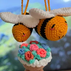 A whimsical combination of a flower bucket keychain and two adorable crochet bees. The bees have sweet, sleepy faces and are perfect as hanging charms.