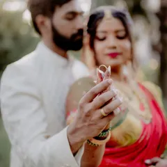 A slightly different perspective of the ring ceremony, with a soft focus that creates a dreamy and romantic atmosphere. The focus remains on their hands and the rings.