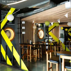 Our space is designed for fun. With bold yellow and black accents and dedicated game zones, it's the perfect backdrop for a night out.