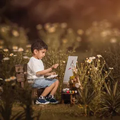 I believe in letting a child's imagination lead the way. For this outdoor session, we set up a small easel in a field of wildflowers and let this little artist paint his world. It’s a perfect example of a personality portrait that tells a unique story about your child.
