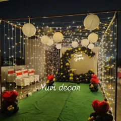 Another perspective of the outdoor canopy setup, showing the full structure draped in fairy lights. This creates a stunning entrance for guests at an evening party.
