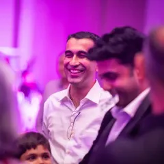 A wide, genuine smile from an audience member. Seeing the crowd this happy is the greatest reward for any performer.