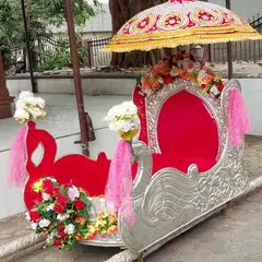 A beautiful swan-themed silver and red Palki available for rent. This open-style Doli is perfect for ensuring the bride is visible and gets amazing photos during her entrance.