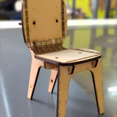 From a digital file to a physical object. This miniature chair was designed on a computer and precisely cut using our laser cutter, showcasing how we blend modern technology with hands-on assembly in our digital fabrication workshops.