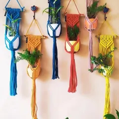 Give your plants a boho home. I craft these macrame plant hangers in a variety of colors and designs, perfect for adding a pop of color and texture to your balcony, window, or any corner of your home. Each one is made from durable cotton cord to securely hold your pots.