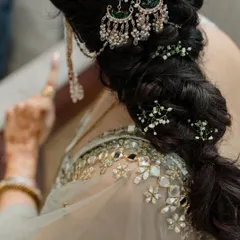 The art of bridal hairstyling. I worked with the hair artist to design this beautiful braided look, incorporating delicate baby's breath and a traditional passa to complement the bride's mirror-work blouse.