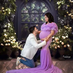 In my studio, we can create any world you imagine. This fairytale setting, with its floral arch and soft lighting, is perfect for capturing those tender moments of connection and anticipation between you and your partner.