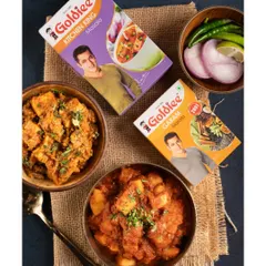 A top-down flatlay showcasing how Goldiee's Kitchen King and Garam Masala can be used in everyday Indian dishes. This visual approach helps customers see the product's versatility and imagine using it in their own cooking.
