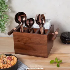 This image showcases a wooden cutlery holder in a dining context. The background props like the pasta bowl and plant help customers visualize how this stylish organizer would look on their table.