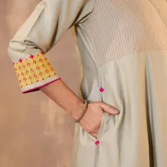 Functionality is key in our designs. This detail shot shows the practical side pocket and the beautiful Pakka embroidery on the sleeve cuff of our Ruhani Sage Green Kurta, blending utility with artisanal beauty.