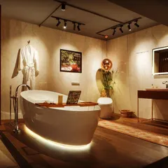 This bathroom design shows how lighting can create a personal spa. I used soft, indirect light under the bathtub for a floating effect, a backlit mirror for clear vanity lighting, and adjustable track lights to turn the artwork into a focal point.