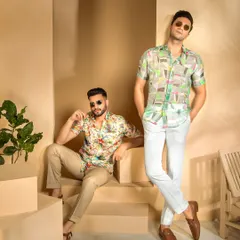 This shot uses varied levels and poses to create a dynamic composition for the menswear shoot. It effectively displays the full outfits, from the printed shirts to the choice of footwear.