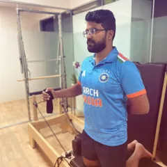This client is performing a rotator cuff rehabilitation exercise on the Pilates reformer. The machine's spring resistance provides a safe and effective way to strengthen the delicate muscles of the shoulder.