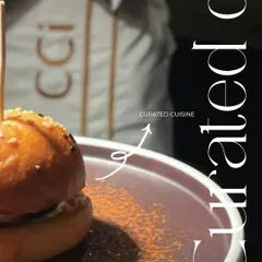 Our service is more than just delivering food; it's about creating an experience. This image, showing a curated gourmet slider with our uniformed staff in the background, represents the synergy and polish that defines a CCI event.
