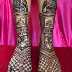 A heavy bridal foot design with elephant motifs and jhumka (earring) patterns, ensuring the bride's feet are as beautifully adorned as her hands.