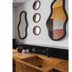 A detail from the 'Aria' master bathroom, where the walls themselves are the art. The reflection in the custom-shaped mirrors reveals the Van Gogh-inspired china mosaic, while the Jaisalmer stone basin adds another layer of natural, earthy texture.