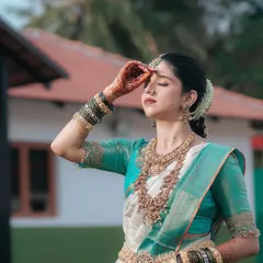A serene and beautiful portrait of the bride, her eyes closed in a moment of quiet reflection amidst the wedding day festivities.