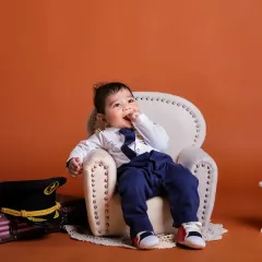 A thoughtful moment for our little pilot. We capture a range of expressions, from playful to pensive, during our themed sessions.