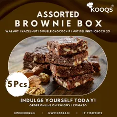 A close up of our Assorted Brownie Box, featuring a stack of rich, fudgy walnut brownies. Each box includes five different varieties, such as hazelnut and double chocochip, making it a perfect dessert to order online for yourself or as a gift.