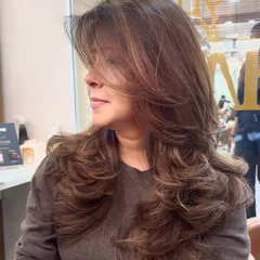 A perfect transformation featuring a new hair color and a fresh layered haircut. The combination creates a voluminous and stylish look.