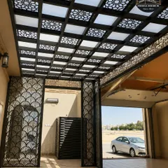 This grand entrance features a pergola with a beautiful laser-cut ceiling and matching decorative gates. The cohesive design creates a powerful and luxurious first impression for any property.