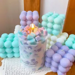 A playful collection of pastel-colored bubble candles and a unique chunk candle. These trendy designs are a fun way to decorate a shelf or desk.