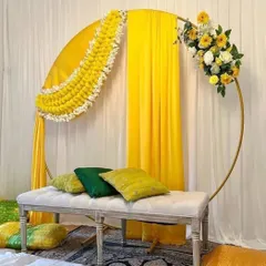 For this haldi ceremony, I used a modern gold ring frame decorated with traditional marigold garlands and bright yellow drapes. The comfortable bench seating makes it perfect for photos and for the main rituals.
