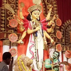 A photograph of the beautifully decorated Durga idol at the pandal. This provides context for my sketches, showing the source of my inspiration and the vibrant, festive environment I was drawing in.
