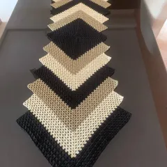 This modern chevron table runner is a real statement piece. I created this design in neutral shades of black, beige, and cream to add a touch of class to a contemporary dining or coffee table.