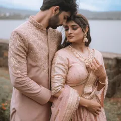 An intimate close-up from a couple's portrait session, highlighting their elegant traditional attire and the quiet connection between them. These moments are timeless.