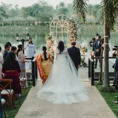 When nature provides half the decor, a minimalist theme can create magic. For Sudhira and Prajwal's lakeside vows ceremony, we used a simple floral arch that beautifully complemented the serene backdrop.