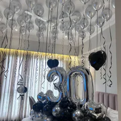 Another angle of the 30th birthday setup, highlighting the density of the ceiling balloons and the way the entire arrangement transforms the room for a surprise celebration.