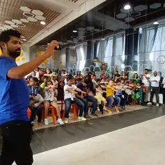 The best magic is interactive! Here, the young audience members at Opus Consulting are getting involved and learning a trick themselves. My workshops are all about participation, not just observation.