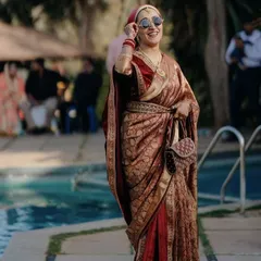 I love the attitude in this photo. We created a unique and stylish saree drape with a velvet shawl for this guest, perfect for a chic, modern look at a winter wedding.