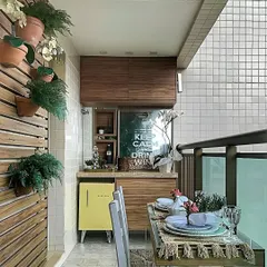 This balcony has been converted into a mini dining and bar area. We built a custom wooden cabinet unit with a countertop and space for a mini-fridge.