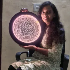 Holding my 3D moon LED light painting. It's a piece of textured art that doubles as a unique lamp.