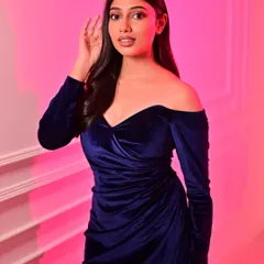 Another shot from the same series, with a pink background that makes the blue dress pop. The makeup is versatile enough to look great against different lighting and backdrops.