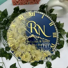 This top-down angle highlights the layout of the 12-inch clock, from the custom monogram to the placement of the preserved varmala flowers and pearl accents.