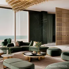 In this living area, we used a rich palette of emerald green and brushed gold to create a sense of opulent comfort. The design balances bold color with clean lines and natural light from floor-to-ceiling windows, overlooking the sea.