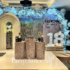 The main stage for the 18th birthday, featuring a shimmering silver backdrop, a modern arched frame, and light-up numbers to mark the special age.