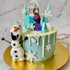 Let it go! This Frozen themed cake is perfect for any little princess, featuring Elsa and Anna, edible snowflakes, and a hand-sculpted fondant Olaf. The white chocolate drip gives it that perfect icy look.