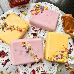 Introducing our Rakhi specials: 'Biscofi-licious' and 'Pista-licious' chocolate bars. These unique, colorful treats are filled with deliciousness and come in beautiful gift packs.