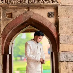 I believe an outfit should complement its setting. Here, my ivory sherwani with its subtle, intricate embroidery stands out against the timeless beauty of historic architecture, creating a picture of grace and sophistication.