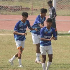 Our players on the field, focused and ready for the game ahead.