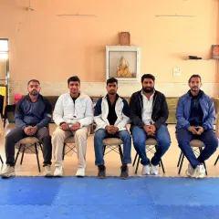 Seated with other respected members of the martial arts community. These gatherings are important for the growth of the sport.
