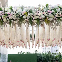 A detail shot of the intricate floral work, featuring thousands of tuberose strings and fresh roses that create a delicate, fragrant curtain effect under the main canopy.