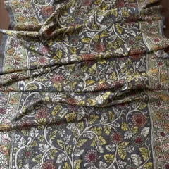 This is a full view of our authentic Srikalahasti Kalamkari art on a charcoal grey silk drape. Every intricate floral vine is hand-painted using traditional techniques and natural vegetable dyes, making each dupatta a unique piece of art.