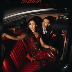 A stylish, cinematic portrait of Kabir and Nikita in a vintage car. This shot from their cocktail night has a classic, old-Hollywood feel, showcasing their elegance and passion.